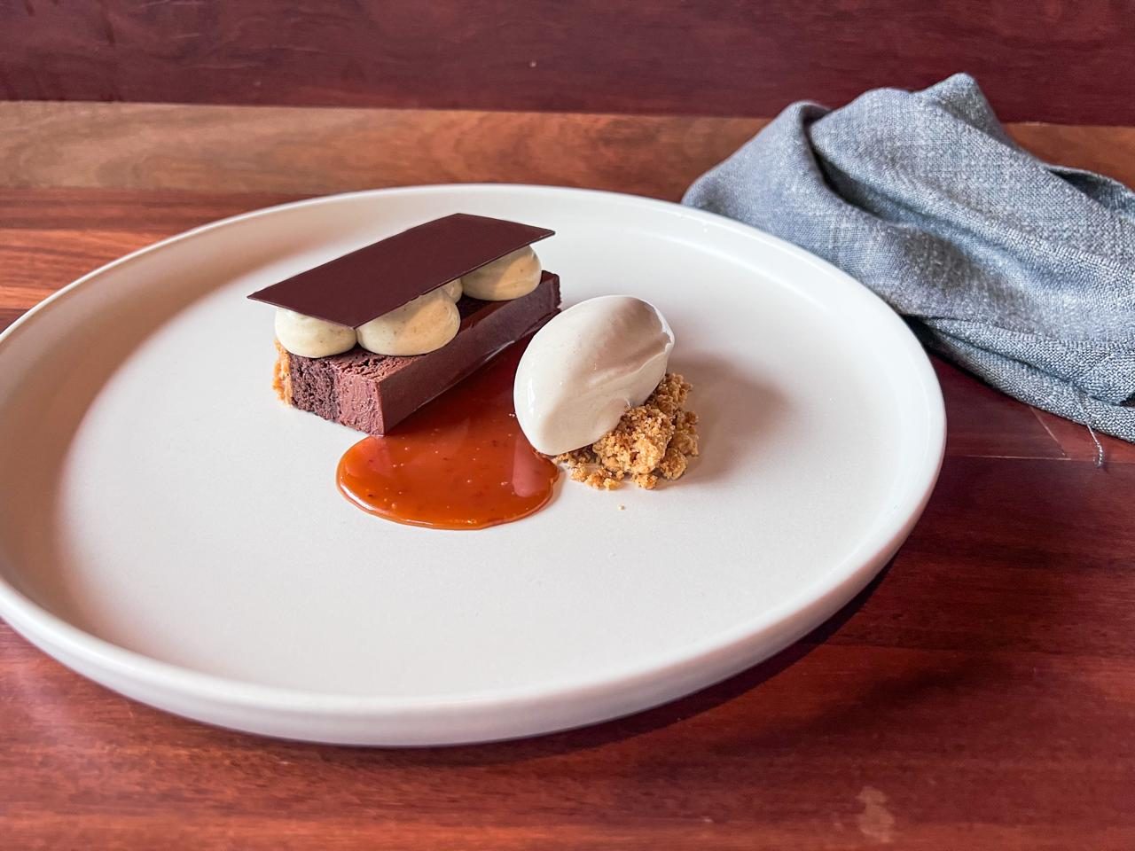 Dark chocolate brownie with banana and tonka caramel, plated by Amruth Sridhara